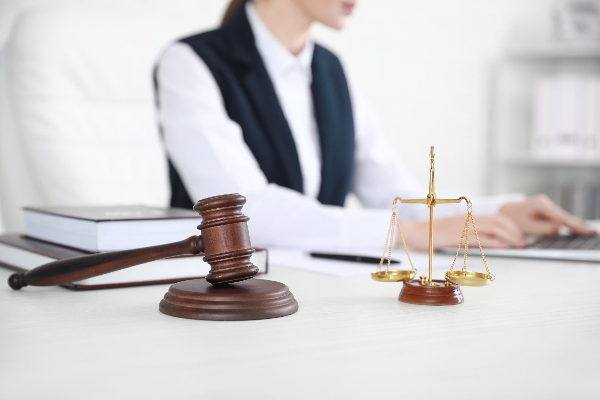 Judge Gavel with Scales on Lawyer's Table